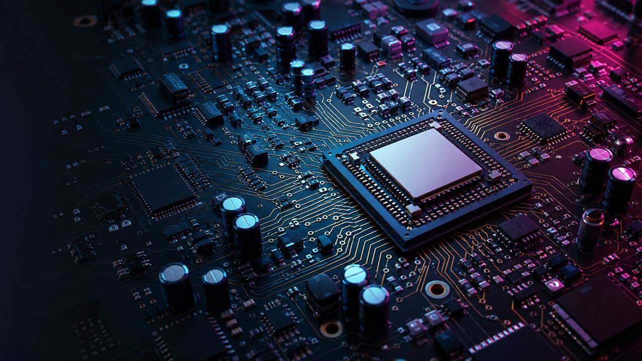 Dark printed circuit board artwork with a central processor, dense electronic components, copper traces, and cyan magenta lighting